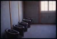 Dachau Concentration Camp : Rebuilt toilets in barracks bathroom