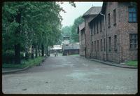 Auschwitz Concentration Camp : View of entry gate and barracks blocks along road
