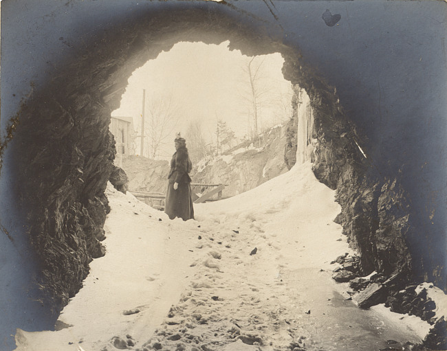 Mine entrance in winter with woman