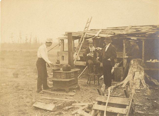Men outdoors with woodstove