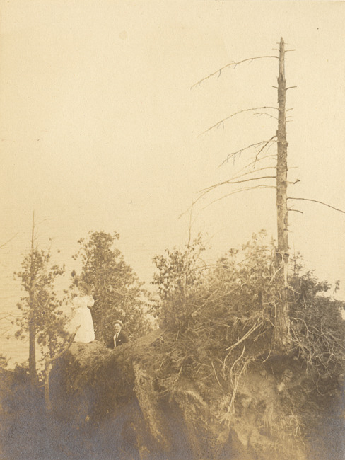 People standing on rock shore