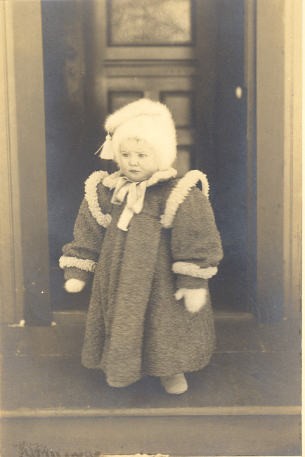 Child with coat and hat