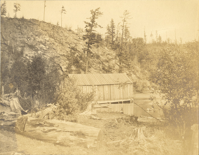 Wooden building on shore of lake