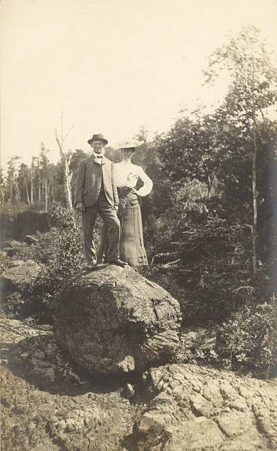 Man and woman standing on a boulder