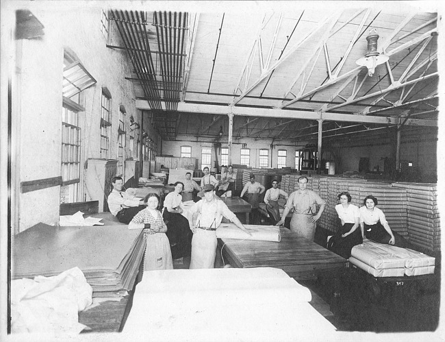 Male and female employees inside Kalamazoo Vegetable Parchment Company