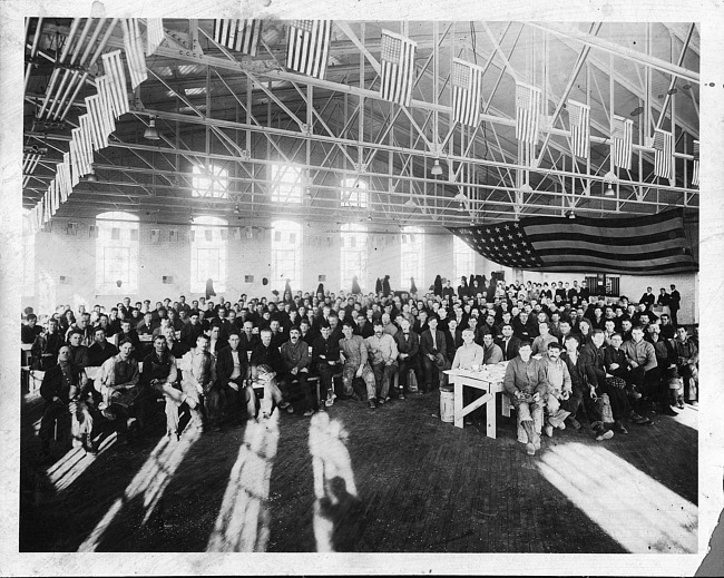 Large group with flags inside Kalamazoo Vegetable Parchment Company