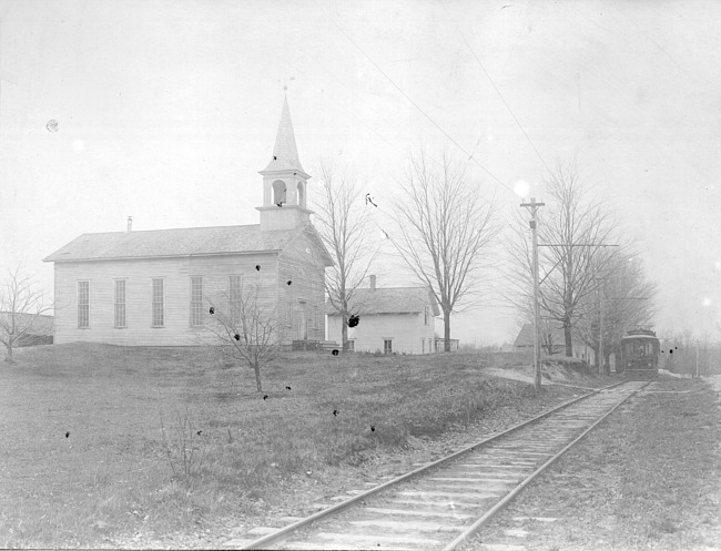 Church by interurban railroad car and track