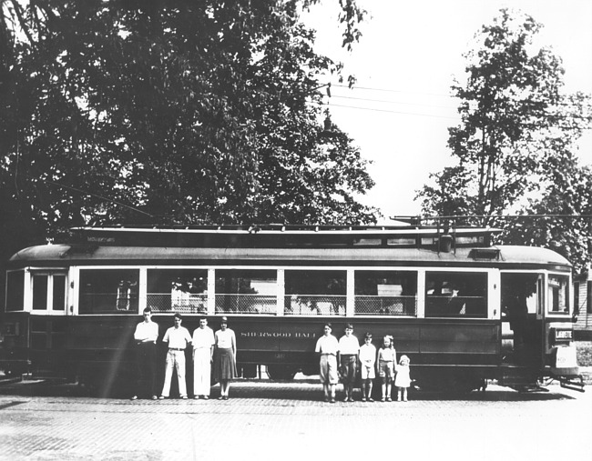 Individuals in front of a cable car
