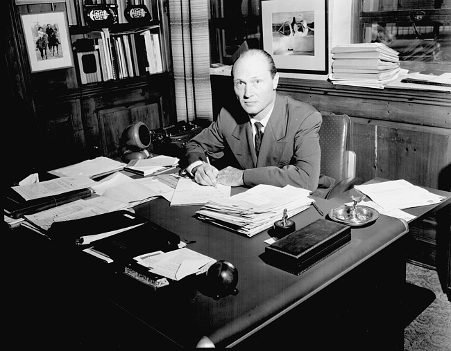 Cass Hough, Daisy Manufacturing Company, at his desk, 1950