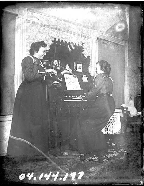 Two Women Playing Musical Instruments