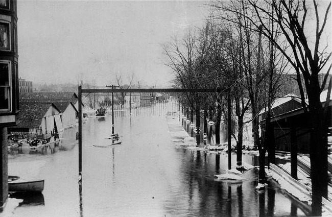 Flooded tracks, Lake Shore & Michigan RR Yards with boat, Lansing, 1904