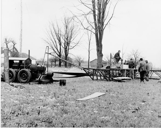 Workers gather around sawmill