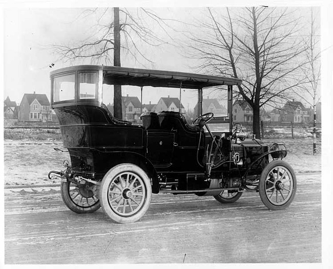 1906 Packard 24 Model S touring car on street with houses in background