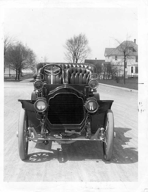 1906 Packard 24 Model S touring car on residential street with house in background