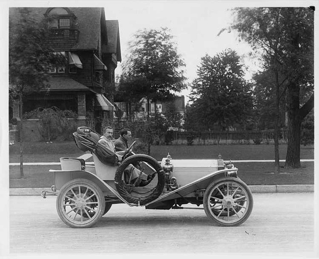 1907 Packard 30 Model U roadster on residential street, driven by Henry Joy