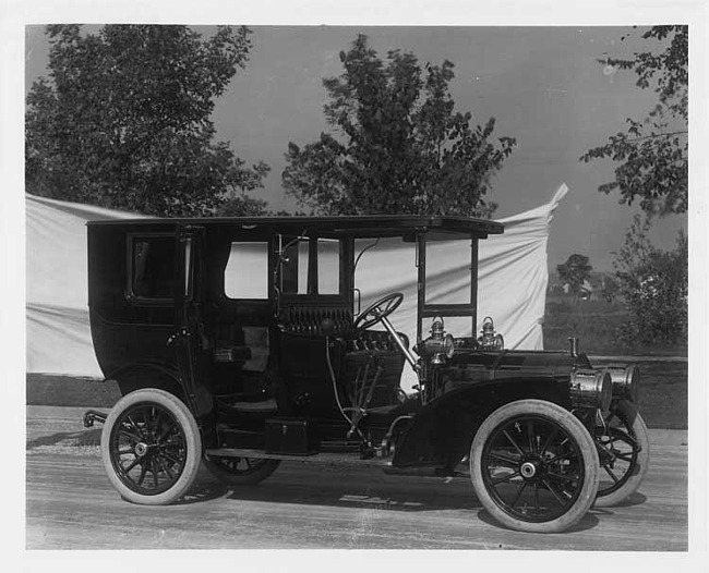 1908 Packard 30 Model UA limousine parked on street trees in background