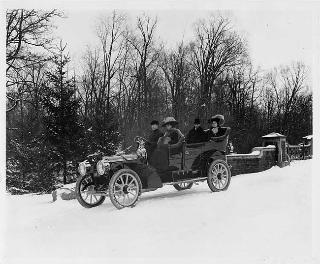 1909 Packard 30 Model UB touring car, with two couples on winter road