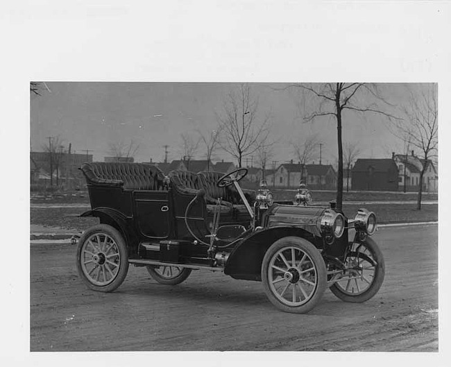 1909 Packard 18 Model NA touring car on residential street, three-quarter front view