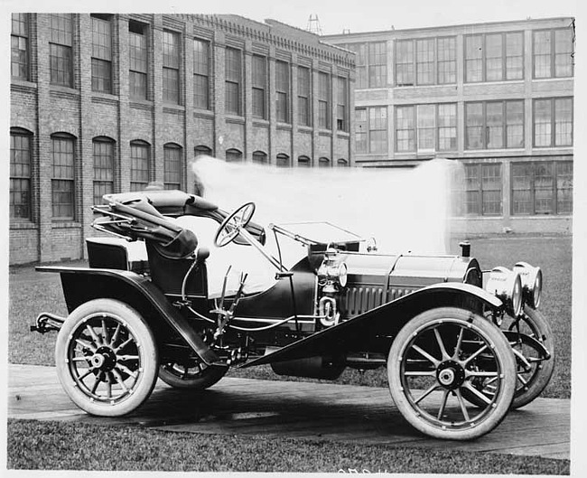 1909 Packard 30 Model UBS runabout, right side, factory buildings in background