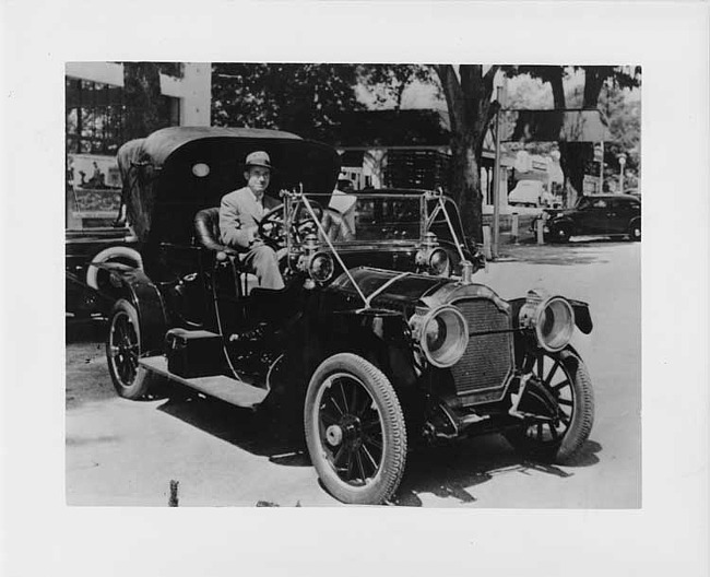 1910 Packard 30 Model UC with male driver, front view, parked on street