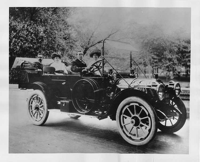 1912 Packard 30 Model UE touring car, parked on street with two couples