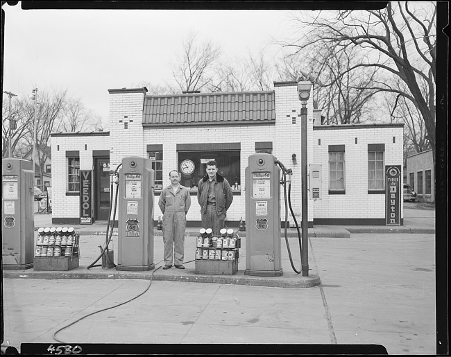 Phillips 66 gas station with two attendants