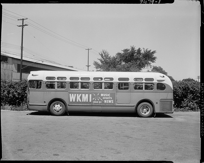 Bus with advertising sign - WKMI Radio