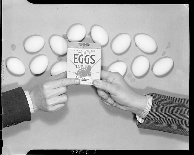 Hands holding dried eggs package