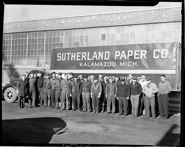 Truck drivers in front of truck, plant