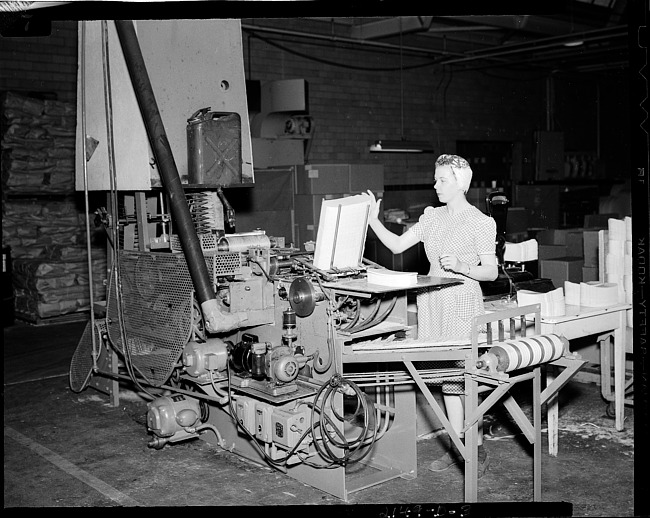 Paper company machine with woman working