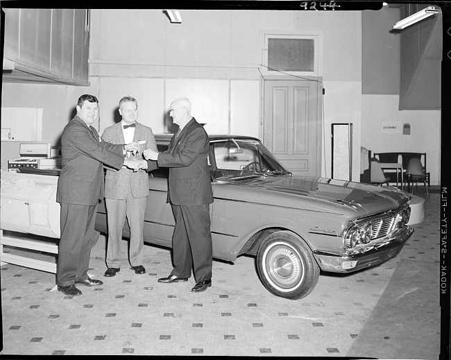 Winner receiving keys to new car