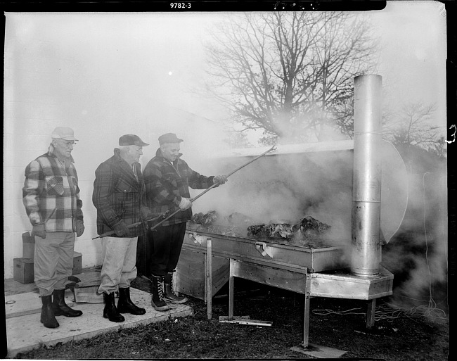 Grand opening Allegan bank - men cooking outside