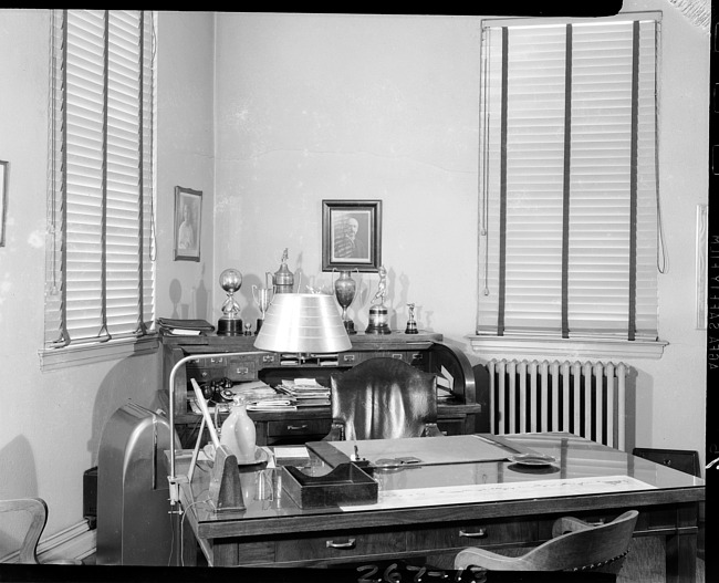 Office desk area with rolltop desk