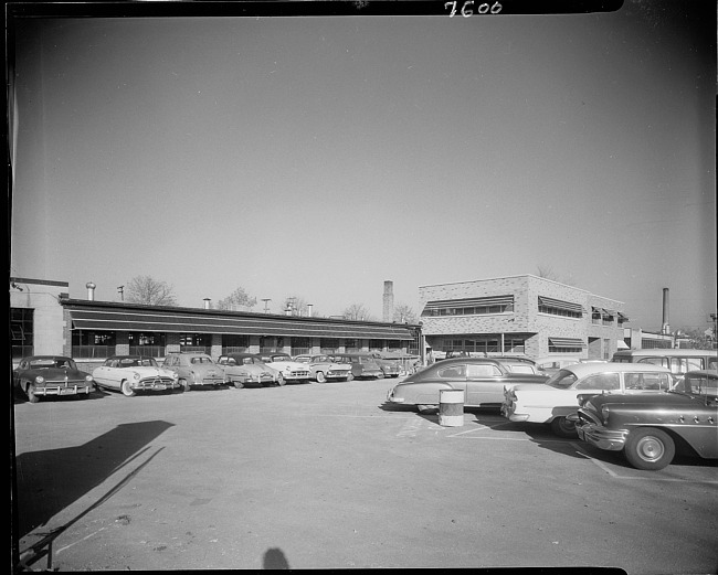Company building and parking lot with cars