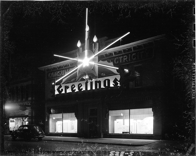 Exterior of building with Christmas decor, nighttime