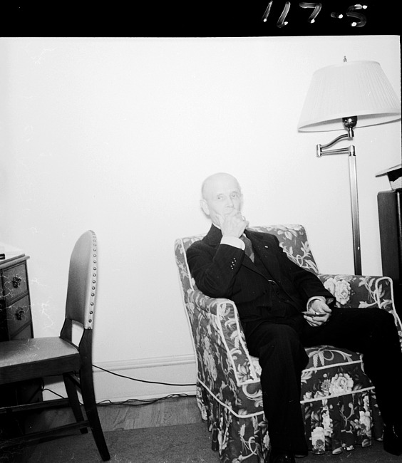 Man seated in armchair in living room