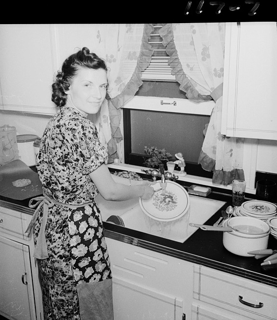 Woman at sink washing dishes