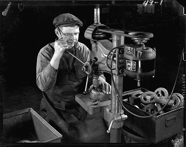 Man working at drill press - from front