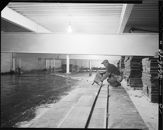 Worker laying down slabs of material