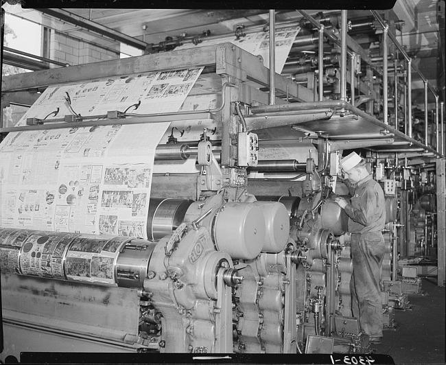 Man monitoring large printing press