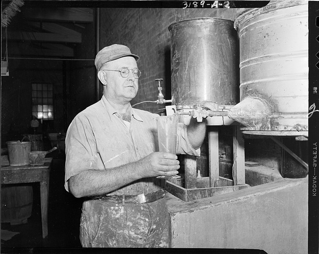Man preparing liquid in paper company plant