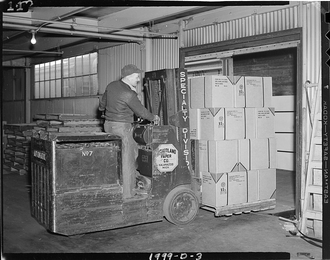 Man moving boxes with lift truck