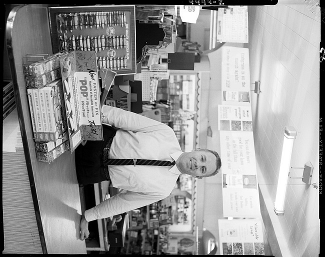 Man behind counter at hardware store