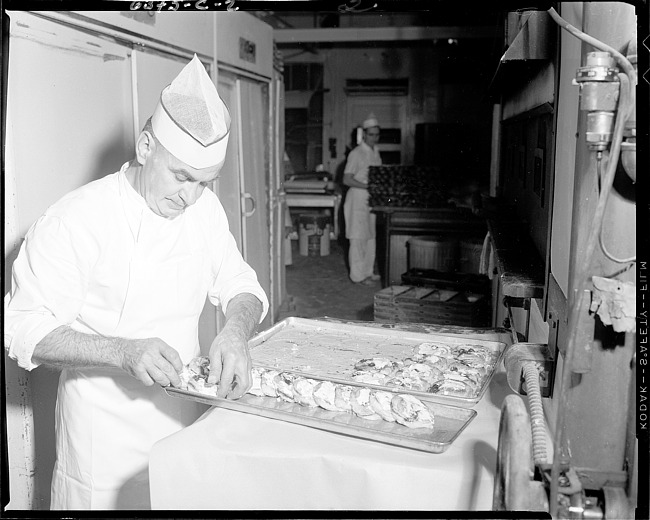 Baker placing pastry on a tray