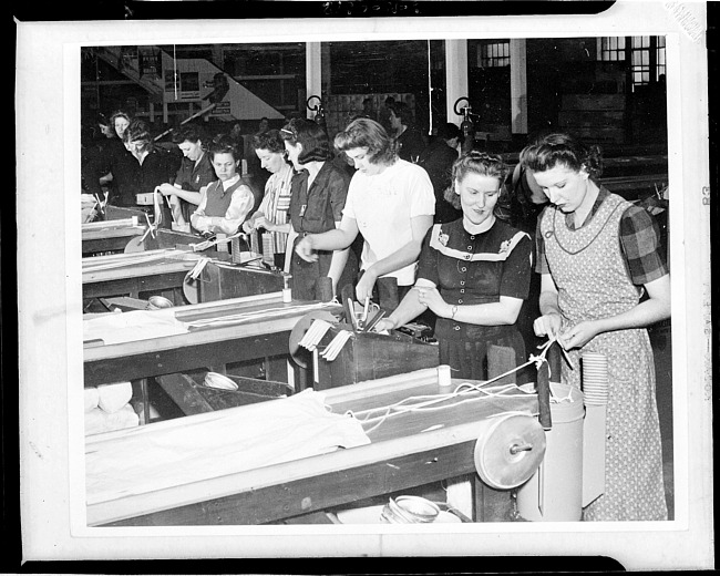 Women workers preparing parachutes for loading into flares