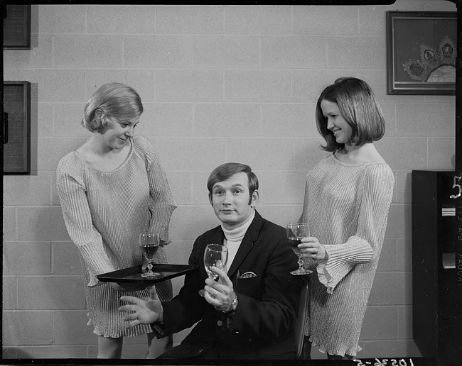 Man and two women posing with goblets