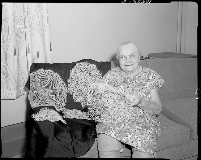 Senior citizen with crocheted doilies