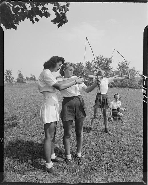 Young girls learning archery