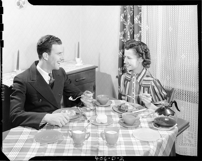 Couple at breakfast table, posing