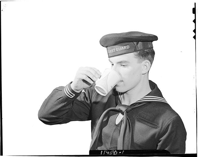 Coast guard drinking from Sutherland Paper Company cup